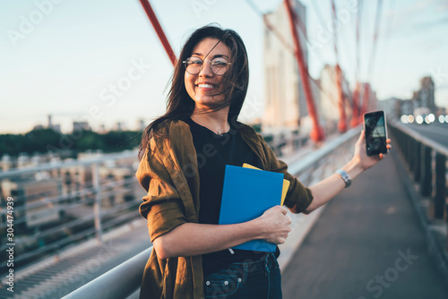 Fotomural Half length portrait of happy female schooler with textbooks for education stand