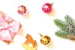 © learesphoto - Flat lay photography New Year present, elegant and classy home decoration. Mockup. Wrapped gift box with pink satin bow ribbon, toy wooden horse, red and yellow balls and Christmas tree branch
