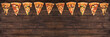 © Alexander - slices of tasty pepperoni pizza looking like christmas flags, creative holiday banner and concept of fast food on wooden background with copy space, top view