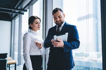 Entrepreneur and female coworker using tablet