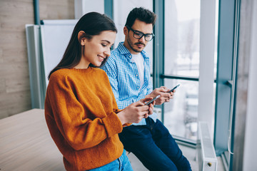 Wall Mural - selective focus on positive hipster girl holding mobile phone connected to wireless internet, happy 