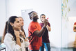 © BullRun - Young coworking students drawing plan on glass wall