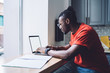© BullRun - Smart black man working on laptop