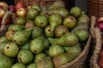 Wall Mural - Stall at farmers fresh food market. Fresh organic produce on sale at the local farmers market. Ripe organic pears in a basket.