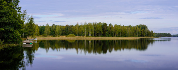 Wall Mural - Picturesque lake with forest on the shore in Aurantola village. Typical nature of Finland.