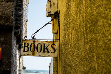 Close Up Of Book Store Signboard In Narrow Alley