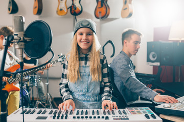 Wall Mural - kids rock band playing instruments in music studio