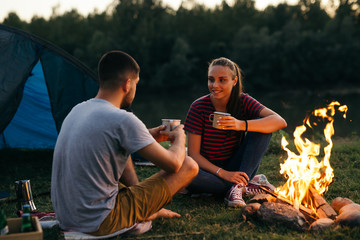 Wall Mural - romantic couple on their camping by the river