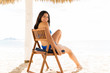 © AntonioDiaz - Happy Woman Relaxing On Chair At Beach In Summertime