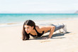 © AntonioDiaz - Woman Doing Push Ups On Beach