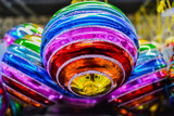 Fototapeta Tęcza - Close up of bright glass rainbow colored Christmas balls, baubles hanging for sale. The concept of the holiday, Christmas, symbol of the rainbow
