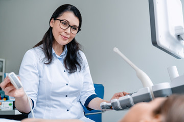 Wall Mural - Doctor doing ultrasound examination of patient in clinic