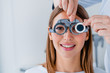 © InsideCreativeHouse - Close up of doctor checking female patient vision with trial frame at eye clinic