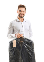 Poster - Male worker of modern dry-cleaner with clothes on white background