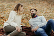 © Goran - Young happy couple enjoying in autumn day and talking to each other
