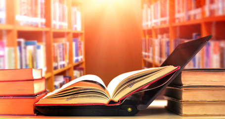 Poster - Stack of books in the library and blur bookshelf background