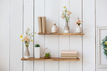 shelf with flowers and books