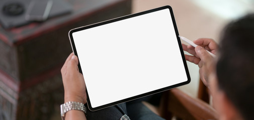 Cropped of businessman using blank screen digital tablet while working on his project