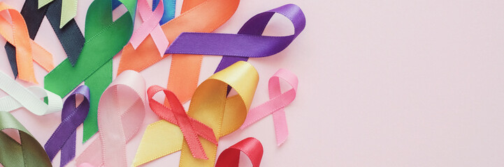 colorful ribbons on pink panoramic banner background, cancer awareness, world cancer day, autism awa