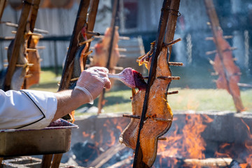 Salmon being  grilled over an open fire using a traditional native american technique at an event in Southern Oregon