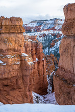 Narrow Canyon Through Orange Sandstone Cliffs After Winter Snow In Bryce Canyon, Utah