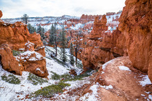 Muddy Trail Through Red Rock Cliffs And Hoodoos Of Bryce Canyon In Southern Utah Desert.