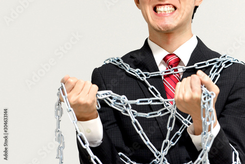 鎖で拘束されるブラック企業の社畜 Stock Photo Adobe Stock