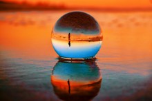 Beautiful Selective Focus Shot Of A Crystal Ball Reflecting The Breathtaking Sunset