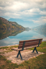 Wooden Bench By The Lake In Focus. Lago Di Cavedine. Italy. Arco