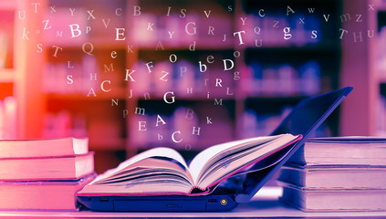 Poster - open book on the table and english alphabet floating above the book