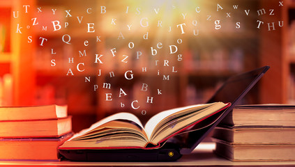 Poster - open book on the table and english alphabet floating above the book