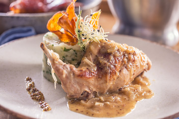 Wall Mural - Rabbit leg with mashes potatoes and decoration on plate in restaurant