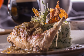 Wall Mural - Rabbit leg with mashes potatoes and decoration on plate in restaurant