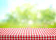 Checkered picnic red table cloth table on natural background.