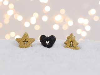 Wall Mural - colorful christmas cookies on white snow with many small, shining lights in the background