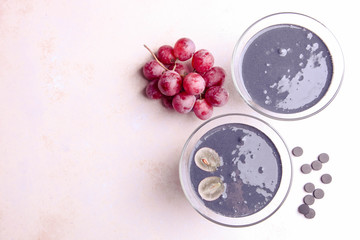 Canvas Print - Black yogurt with activated carbon and red grapes