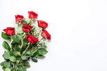 Beautiful Bouquet Of Red Roses And Baby's Breath White Flowers Isolated On A White Background, Top View With Copy Space.
