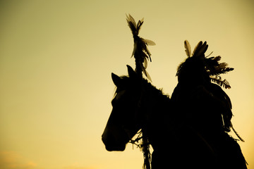 Wall Mural - The Indians are riding a horse and spear ready to use In light of the Silhouette