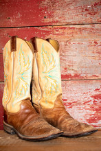 Cowboy Boots On Red Barn Board