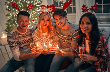 Wall Mural - Group of friends celebrating Christmas at home