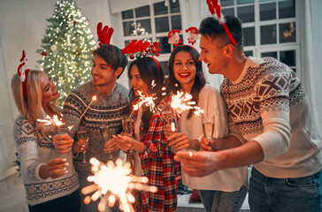 Wall Mural - Group of friends celebrating Christmas at home