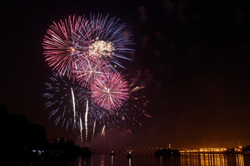 Fireworks over the river.  Holiday in the city. Beautiful golden firework display for celebration happy new year. And merry christmas in the night sky