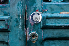 A Green Old Wooden Door With Lock