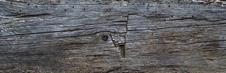 Wall Mural - The wall of old wooden house in traditional swiss alpine village. Rural mountain chalet. Dark wood texture background surface with old natural pattern