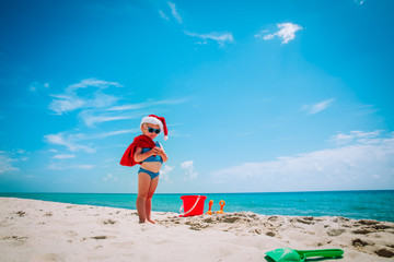 cute little girl celebrating christmas on tropical beach