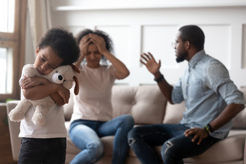 Wall Mural - African boy feels lonely embraces toy suffers from parents scandal