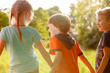 © Andrey - A group of happy children of boys and girls run in the Park on the grass on a Sunny summer day . The concept of ethnic friendship, peace, kindness, childhood