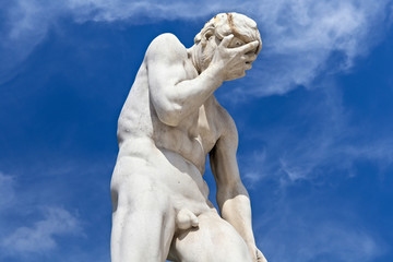 Wall Mural - View of the marble sculpture Cain after killing his brother Abel (1896) by Henri Vidal (1864-1918) in the Tuileries Park, Paris, France.