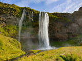 Fototapeta Tęcza - waterfall among rocks in Iceland 