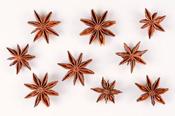 Anise star. Some star anise fruits. Close-up on white background with shadows, flat lay view of chinese badiane spice or Illicium verum.